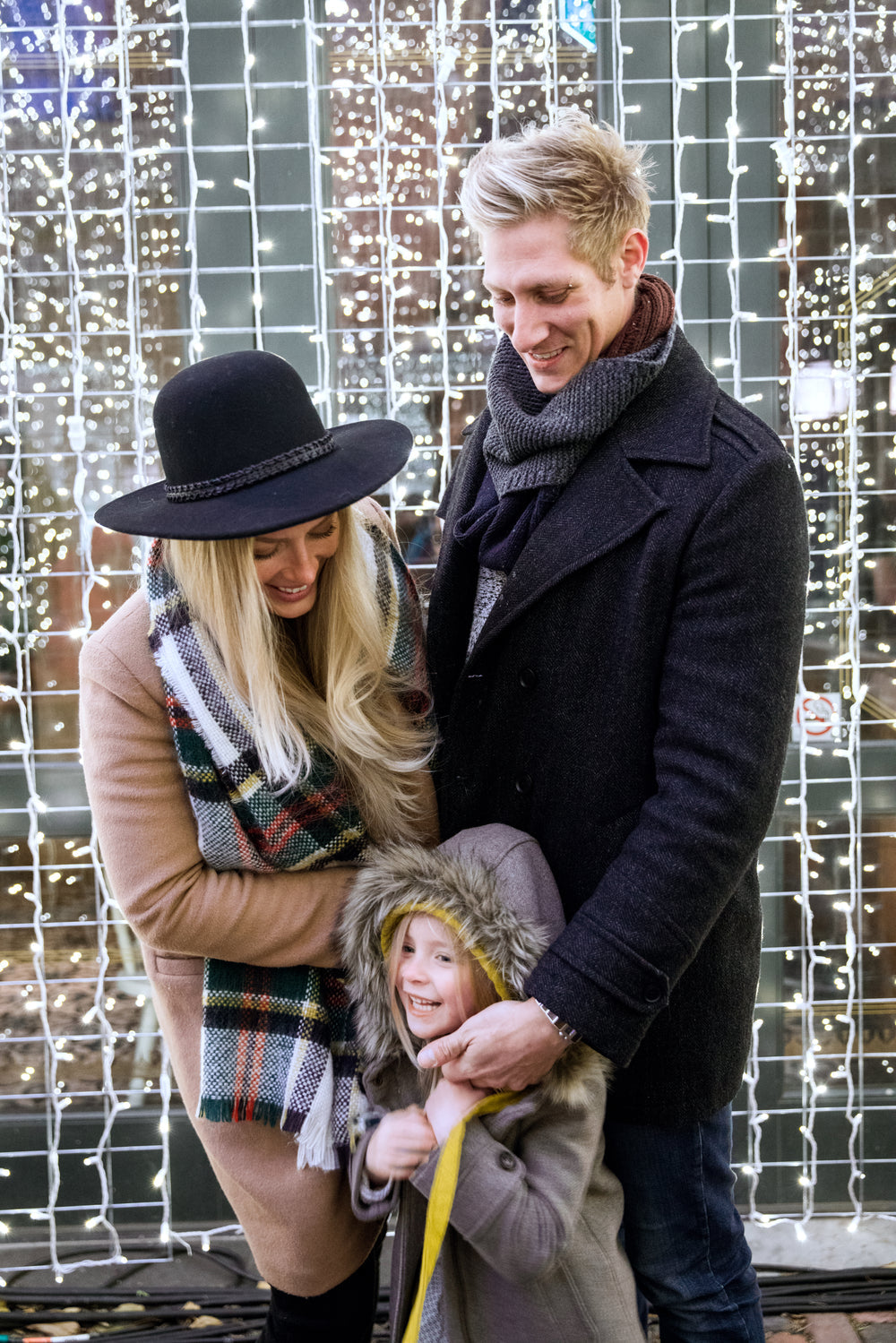 Family laughing together during a celebration with lights