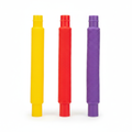 Three pop tubes in yellow, red and purple on a white background