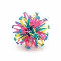 Starburst Ball expandable sphere toy in pink, yellow and blue on a white background