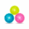 Three light-up spikey sensory balls in yellow, pink and blue on a white background